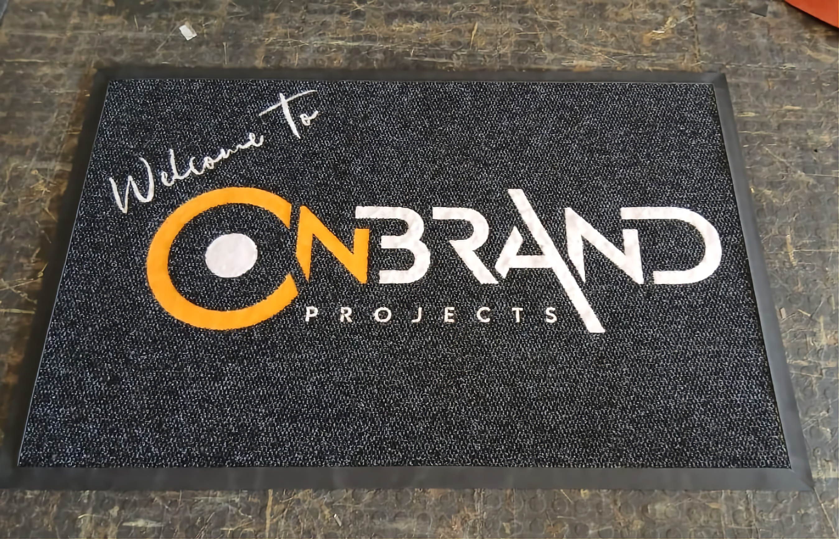 Reception mat with embroidered corporate logo