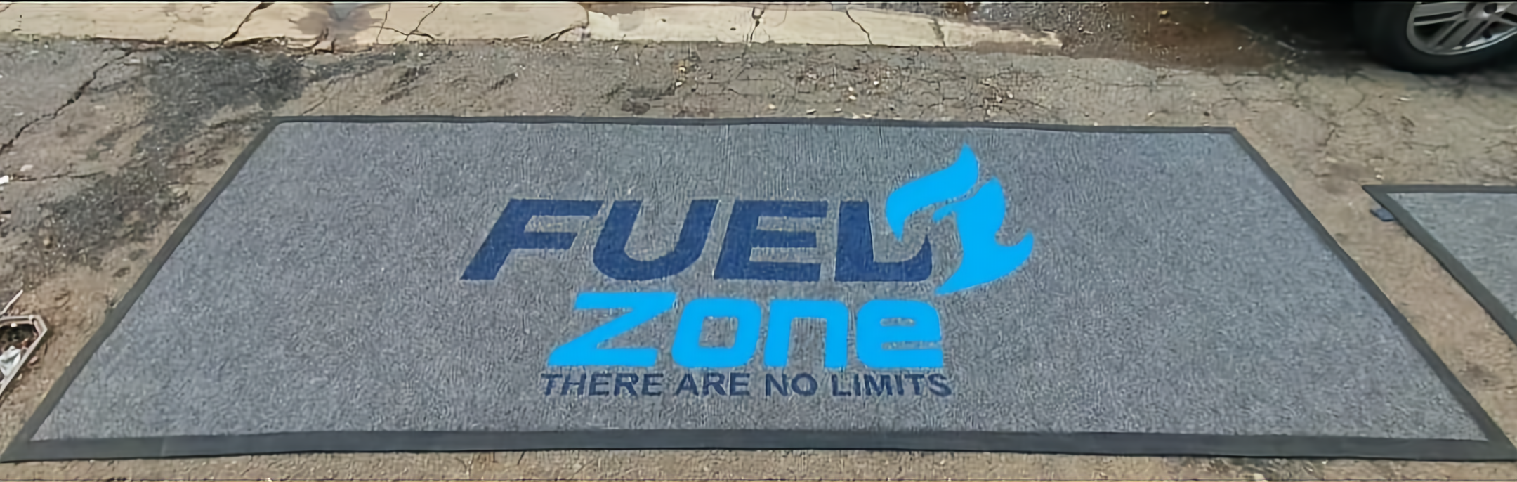 Branded entrance mat at a car dealership service entrance